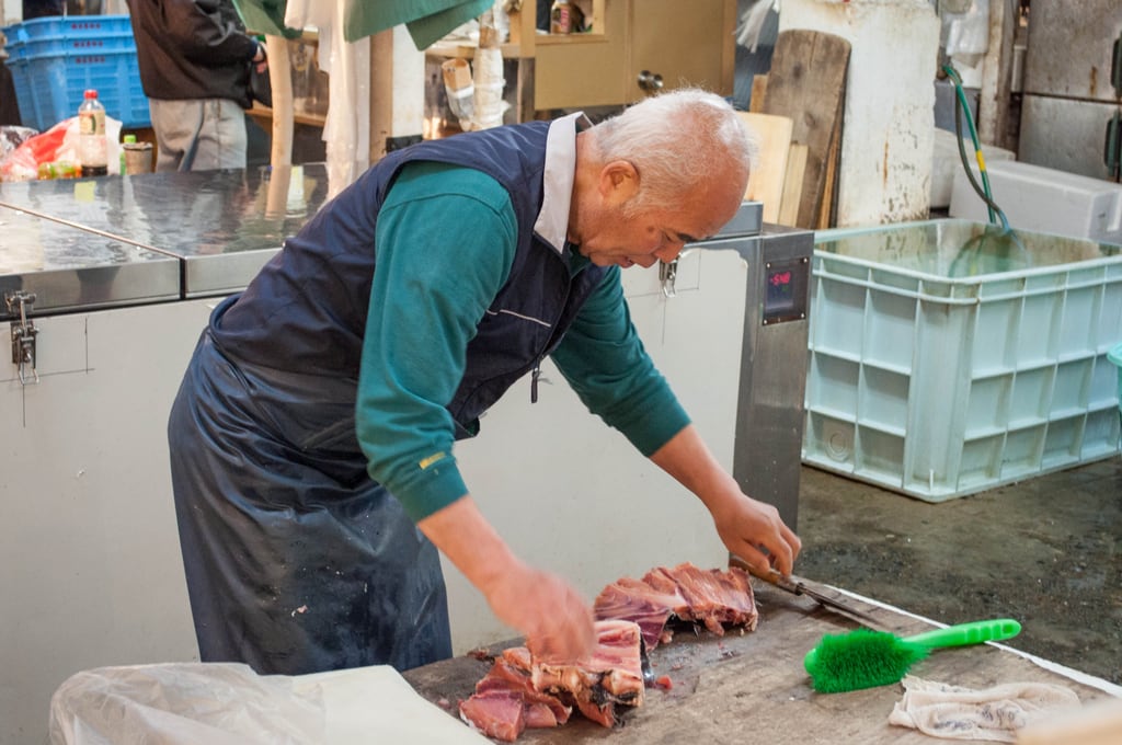 Older man chipping tuna