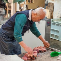 Older man chipping tuna