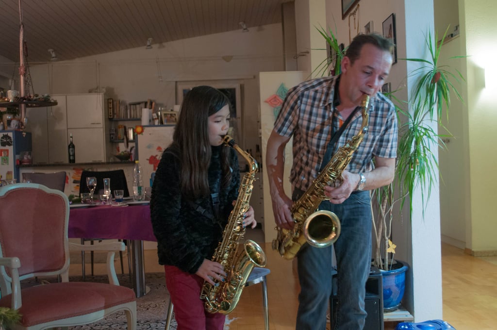 Father and daughter playing sax