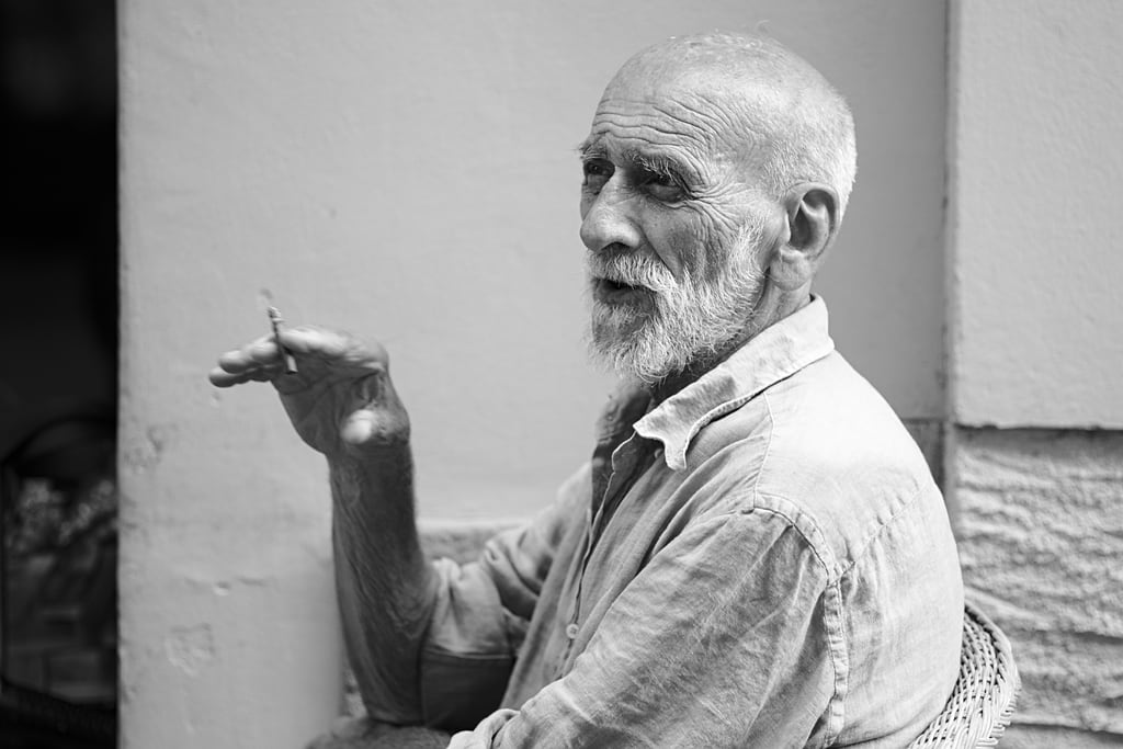 An old man in his chair on the street of Cannobio, Italy.   Via https://jeena.net/photos/443
