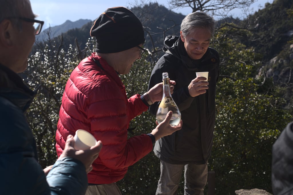 Japanese men drinking sake at top of Miyajima Japan 2020