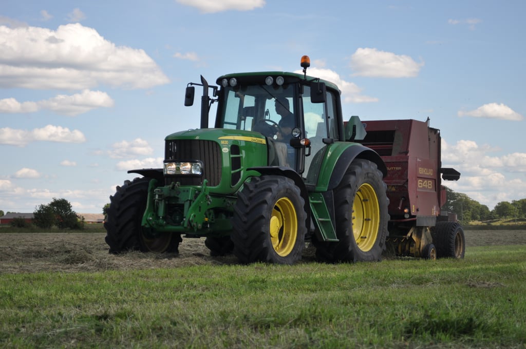 Tractor collecting straw