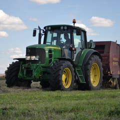 Tractor collecting straw